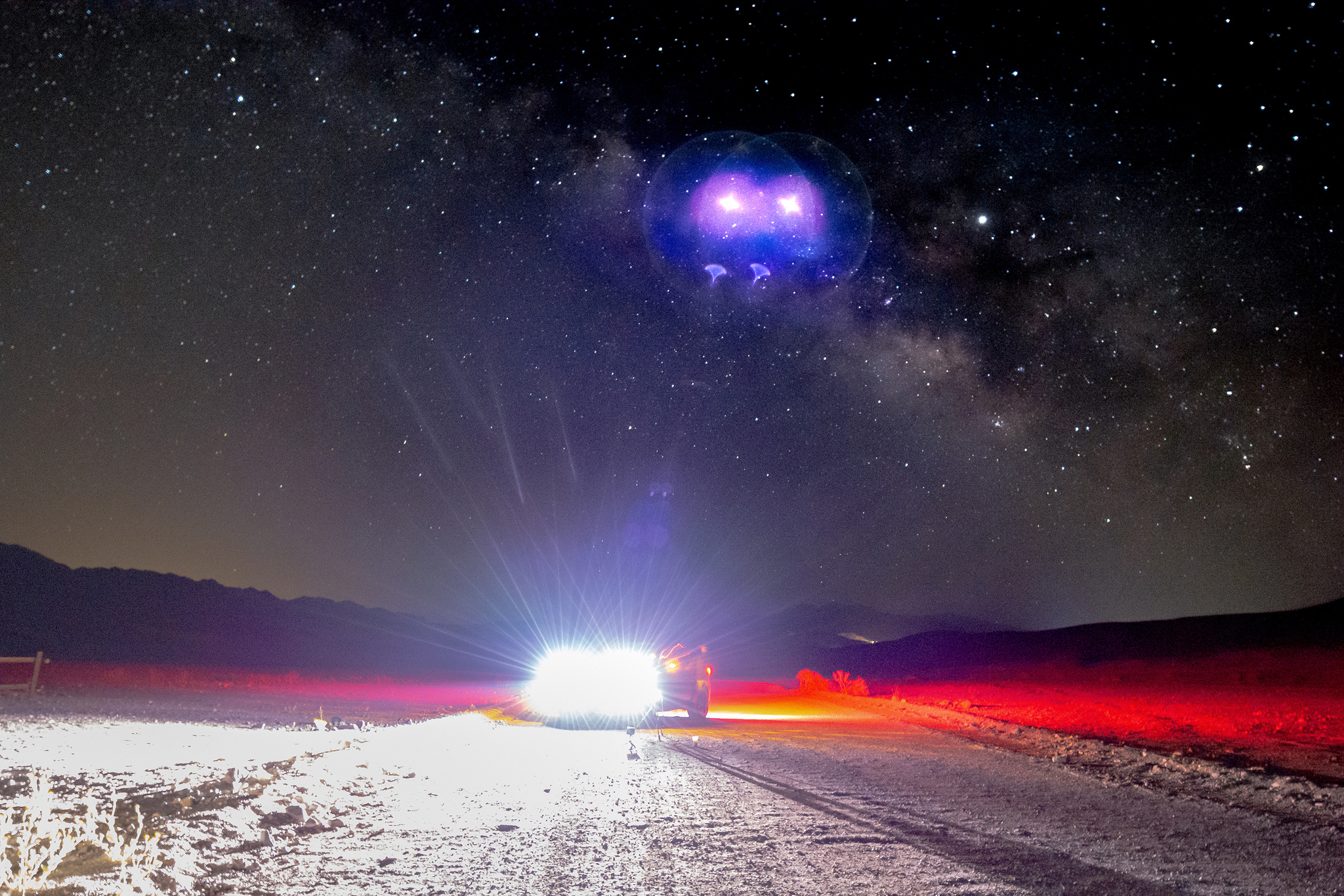 The Milky Way Rises Over a Jeep with its headlights on